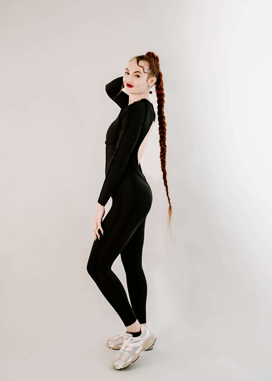 Coach Jamie standing in profile, black athletic wear